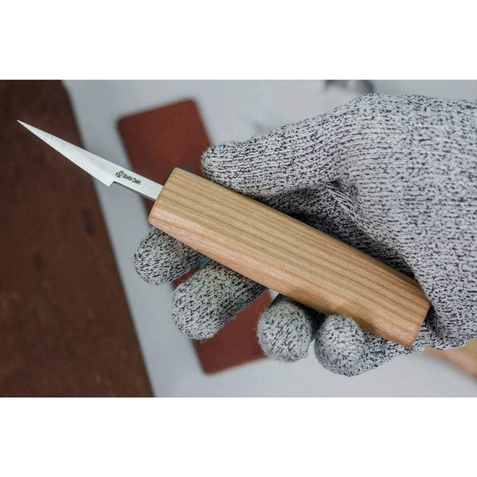 Hand wearing a glove and holding a Beavercraft knife