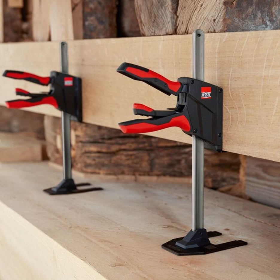 Bessey Tools Beyceps holding a wooden board in place on a wooden surface.