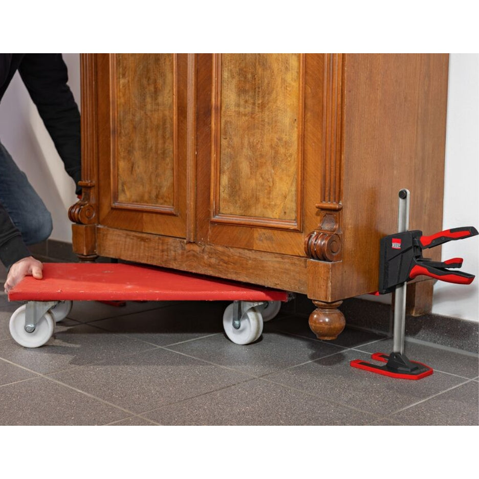 Wooden cabinet being lifted with Bessey Tools Beyceps to allow a dolly to be slid underneath