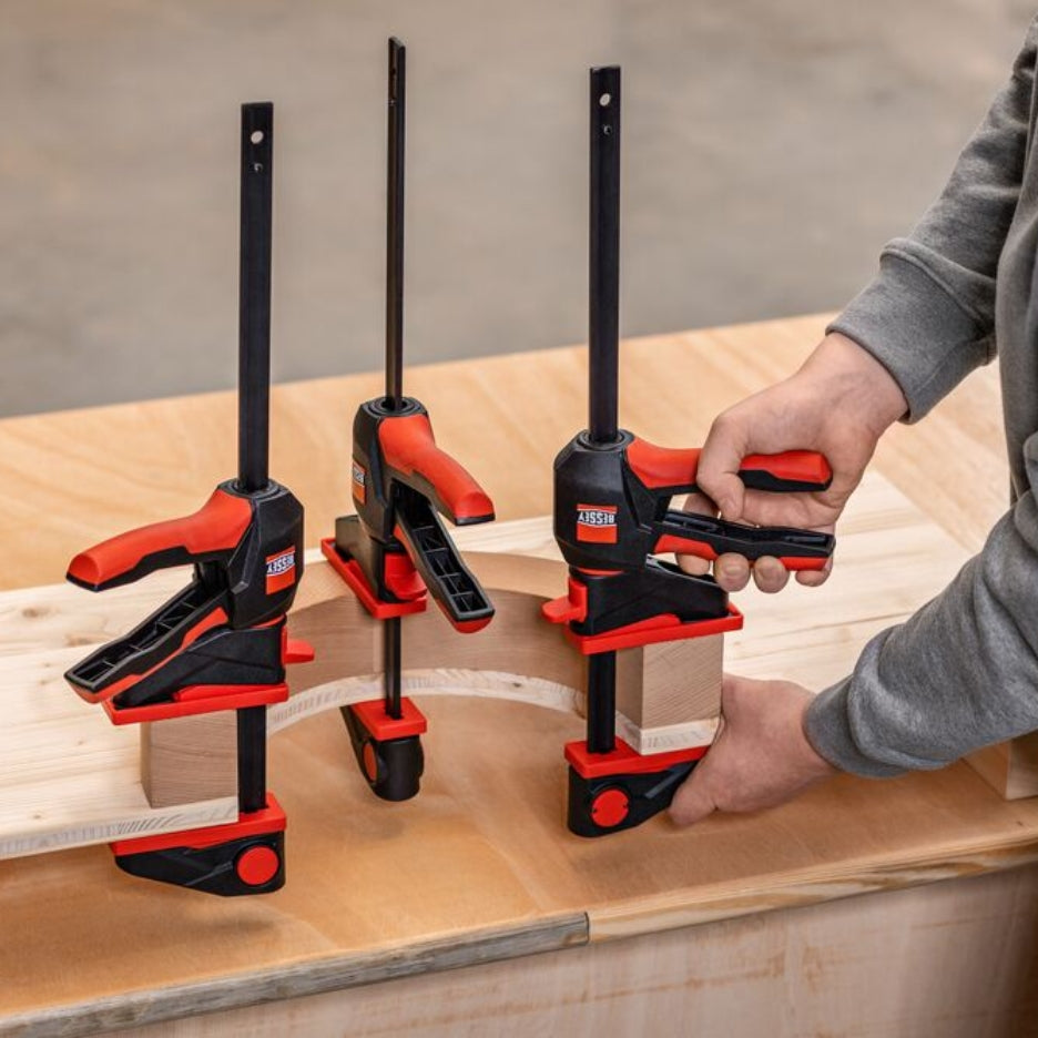 Man holding Bessey Tools Trigger Clamps with 360° rotating handle