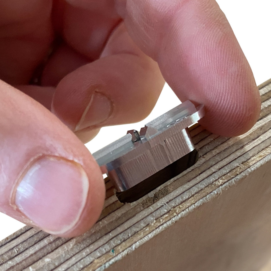 Hand holding FastCap mortise marker close to a mortise