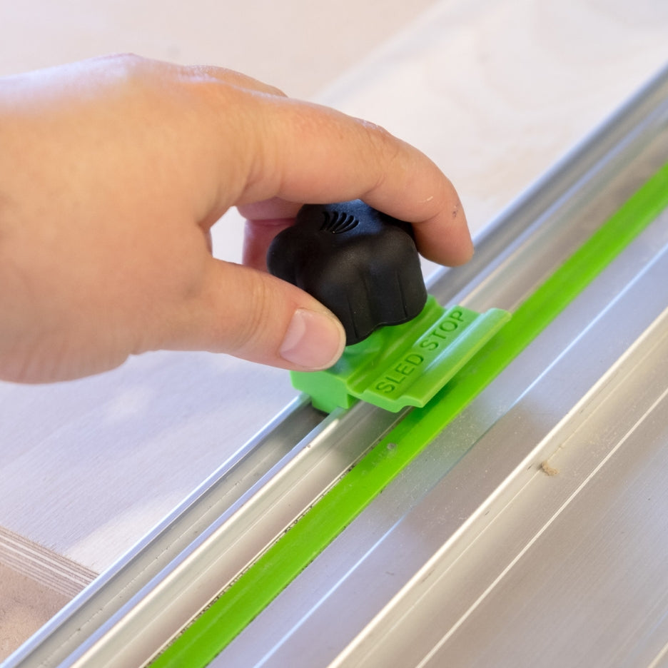 Hand holding FastCap Sled Stop