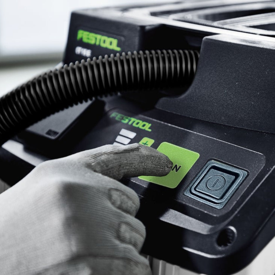 Hand pressing "clean" button on Festool 15 Litre Cleantec HEPA Dust Extractor CT 15 E HEPA