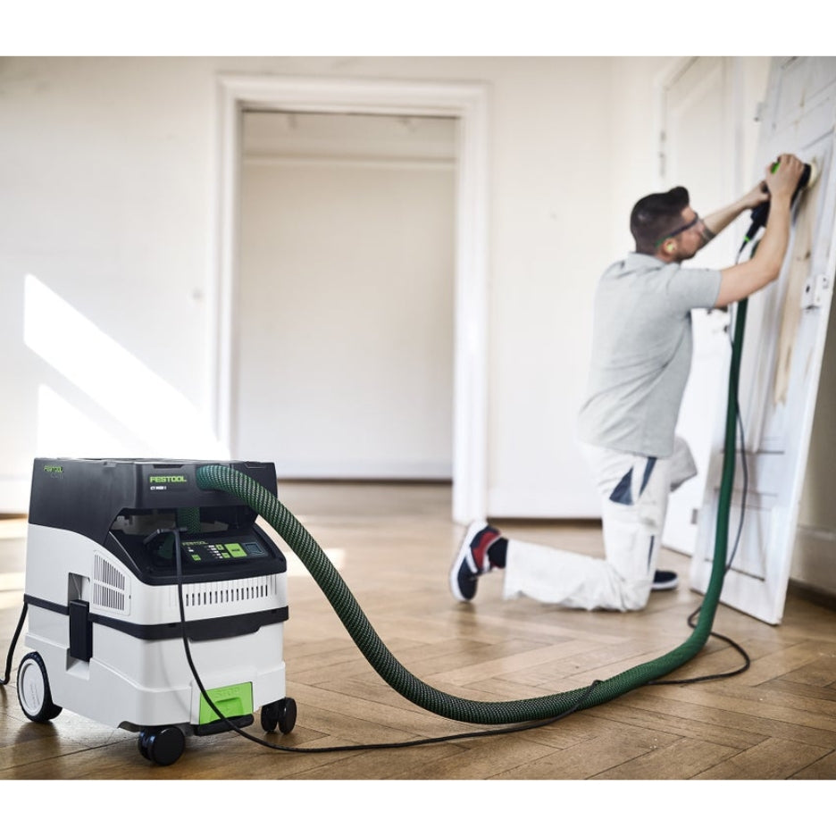 Man sanding door with sander attached to Festool 15 Litre Cleantec HEPA Dust Extractor with Autostart and Bluetooth CT Midi I HEPA