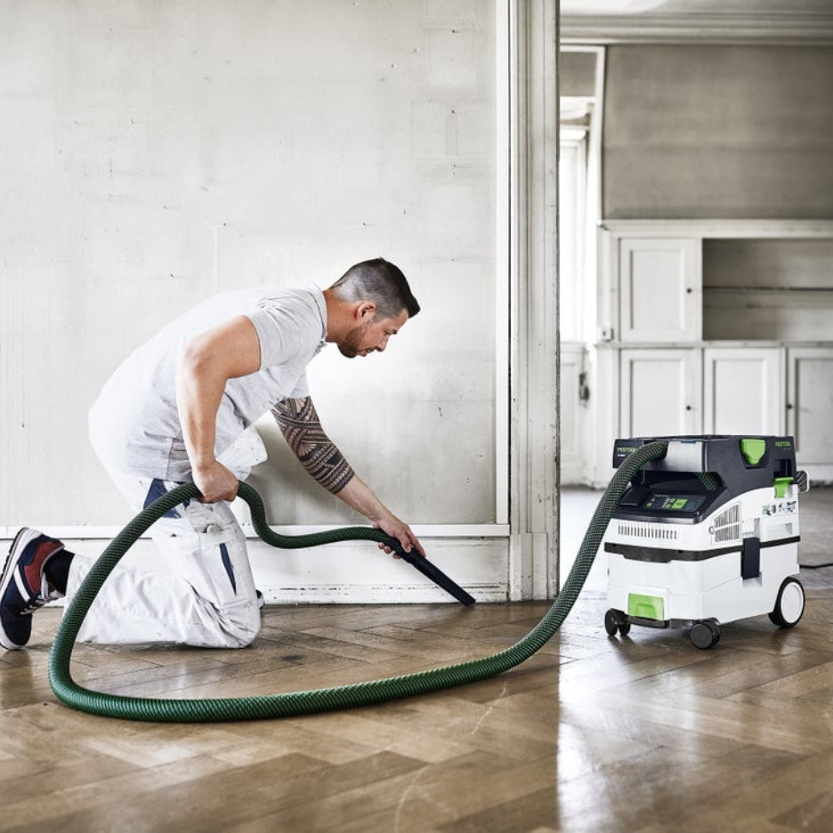 Man vacuuming floor using Festool 15 Litre Cleantec HEPA Dust Extractor with Autostart and Bluetooth CT Midi I HEPA
