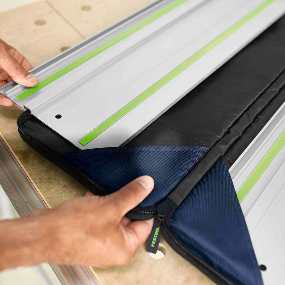 Hands holding Festool guide rail in guide rail bag