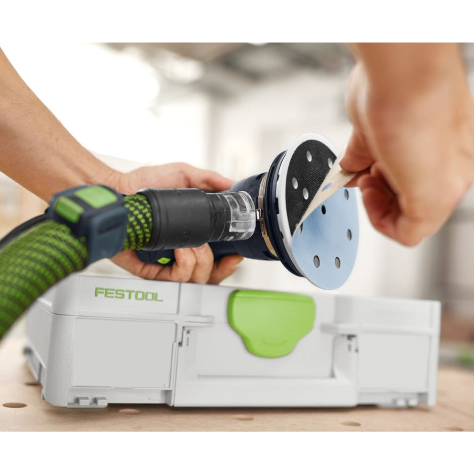 Hands removing Granat abrasive disc from sander