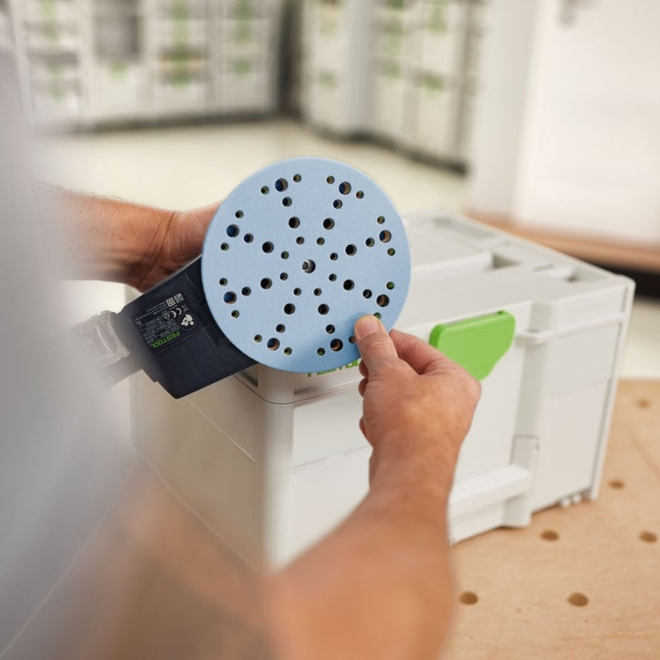 Hands removing Granat abrasive disc from sander