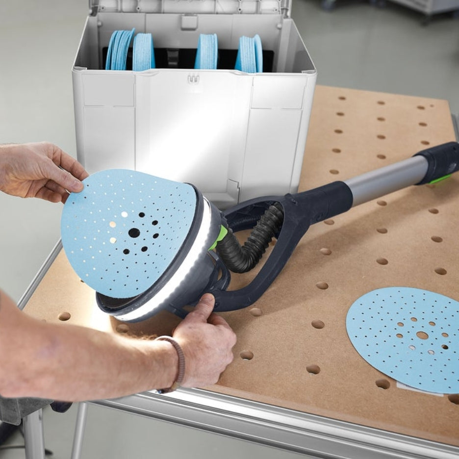 Hands removing Granat abrasive from Planex sander
