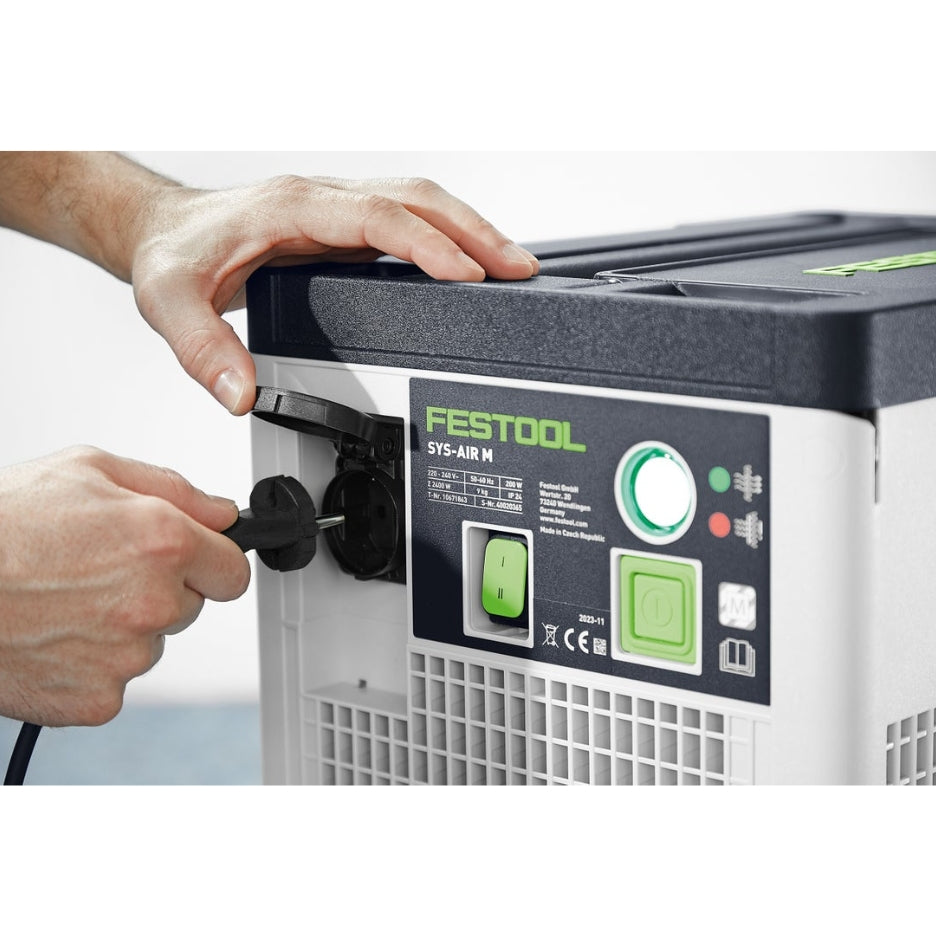 Hands plugging power cord in Festool Air Filter SYS-AIR