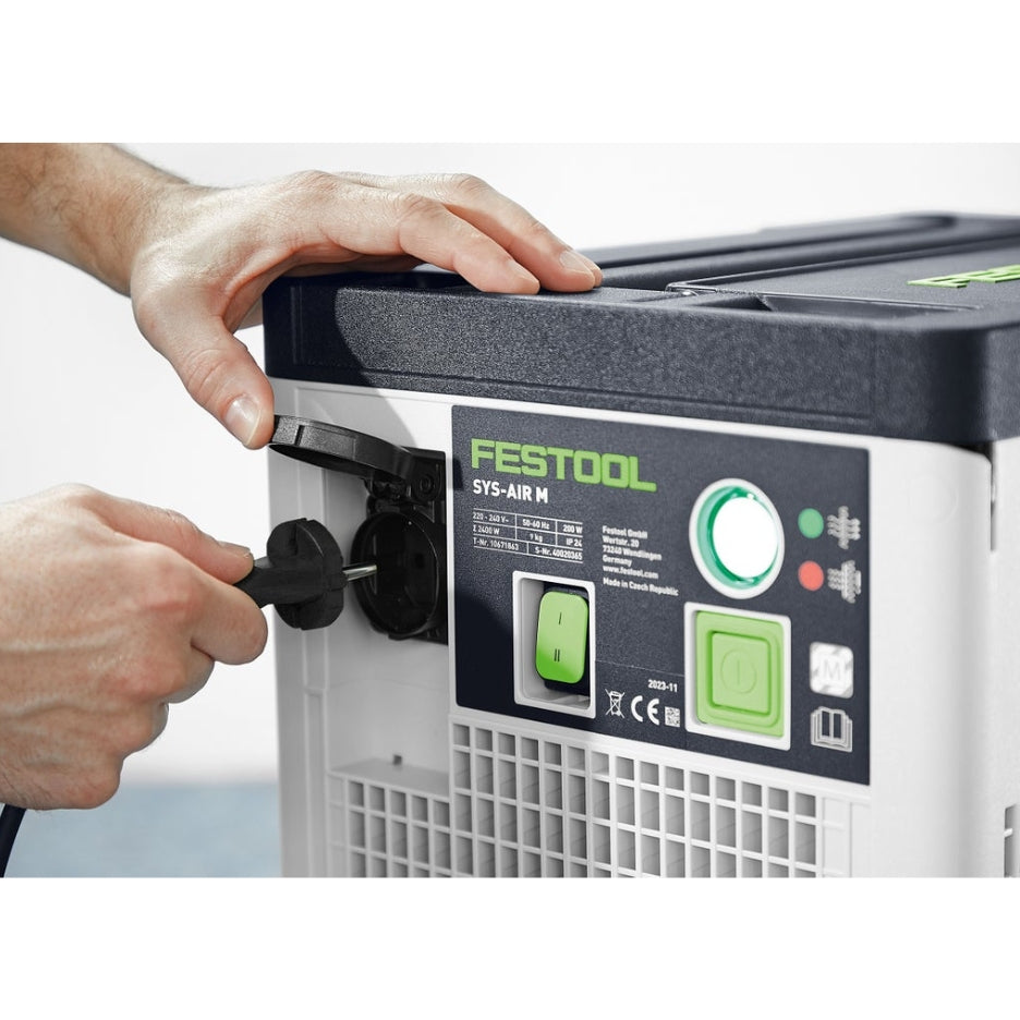 Hands plugging power cord in Festool Air Filter SYS-AIR HEPA