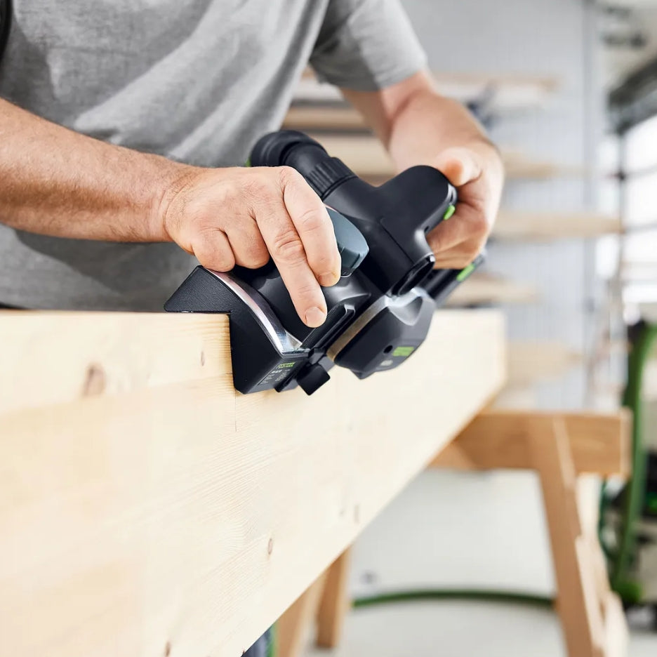 Man using HLC 82 cordless planer with FNS-HLC 82 chamfer adaptor
