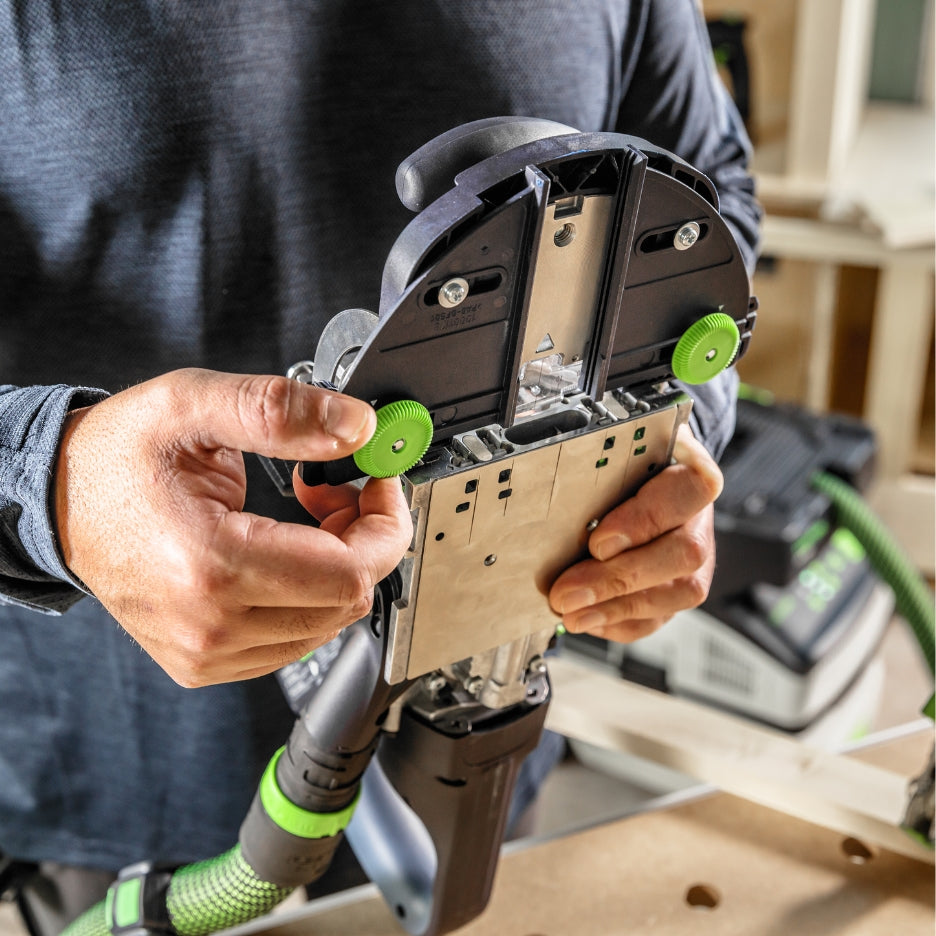 Person adjusting Festool Cordless Domino Joiner DFC 500 support bracket
