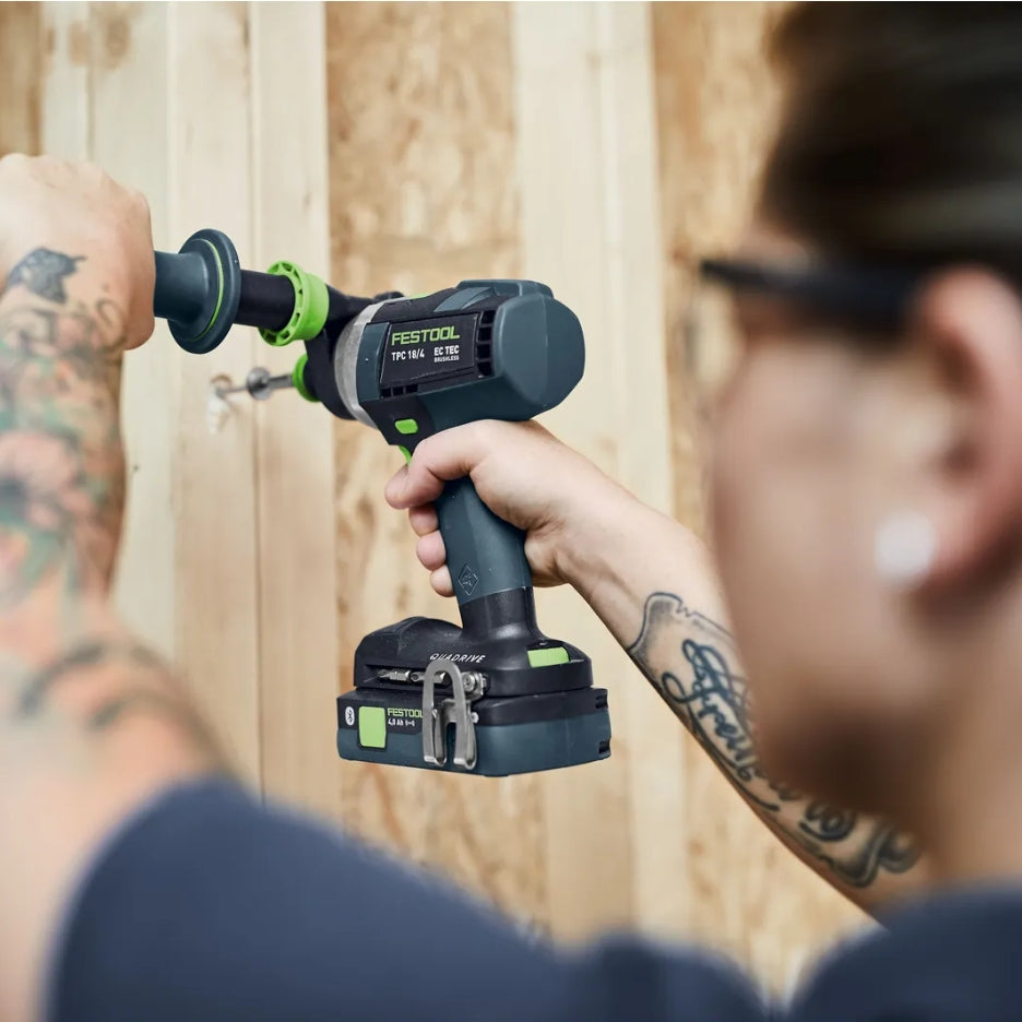 Person using Festool Cordless Hammer Drill TPC 18/4l on wooden studs