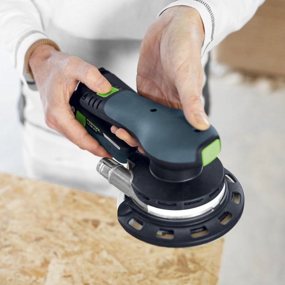 Hands holding Festool ETSC 2 150 while pushing button