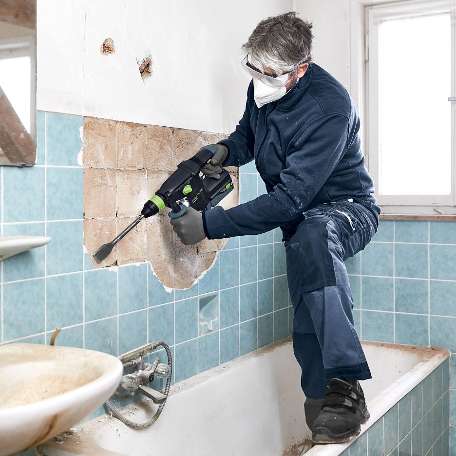 Man using Festool KHC 18 to remove tiles