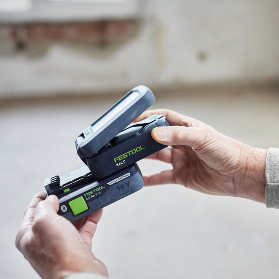 Hands inserting battery in Festool Cordless Task Light SYSLITE KAL C