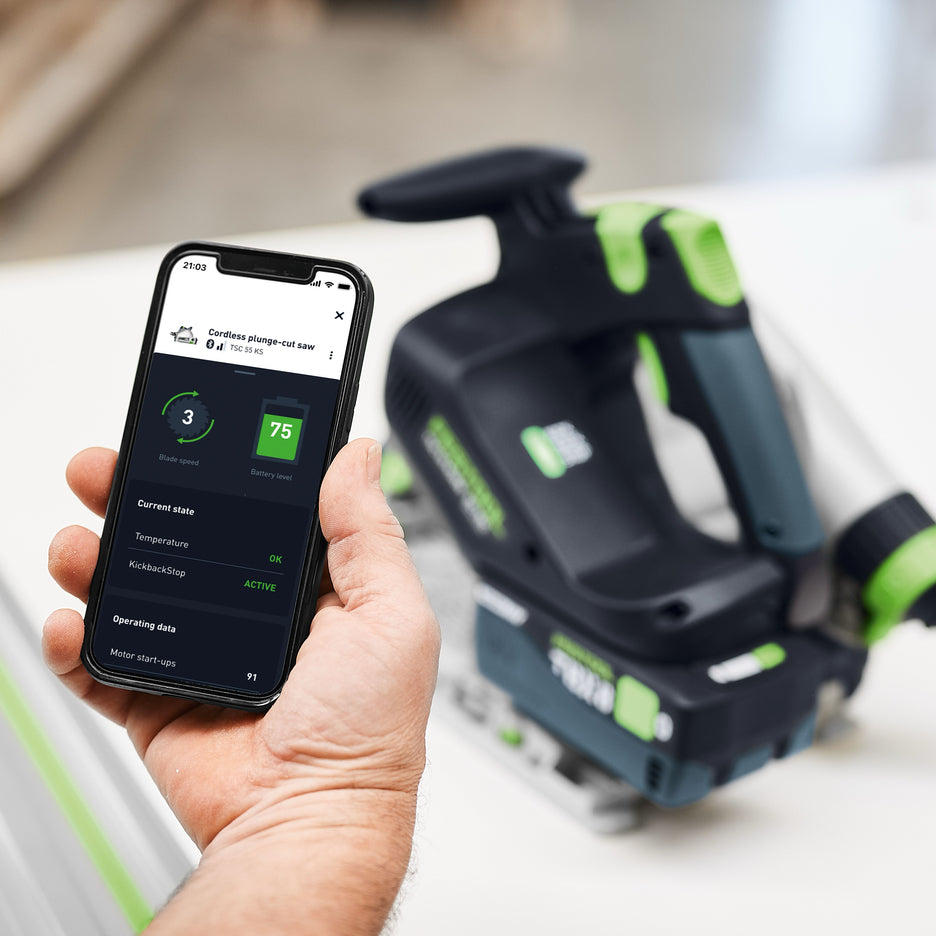 Man checks Festool app to check the status of TSC 55 KS, including blade speed, battery charge, temperature, and KickBack Stop, motor start-ups
