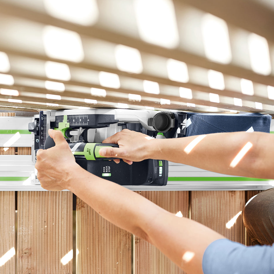 Top view of woodworker cutting the ends of deck boards adjacent to a lattice panel using guide rail.
