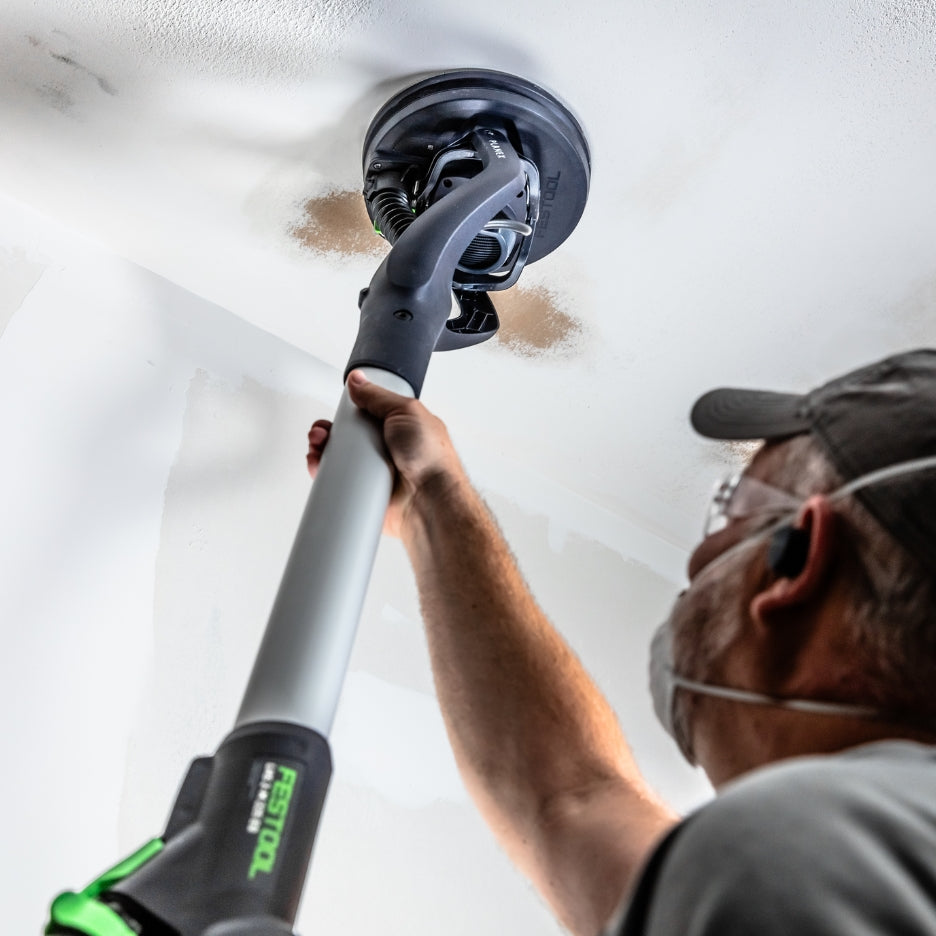 Man using Festool Drywall Sander LHS 2-M 225 EQ Planex to sand ceiling