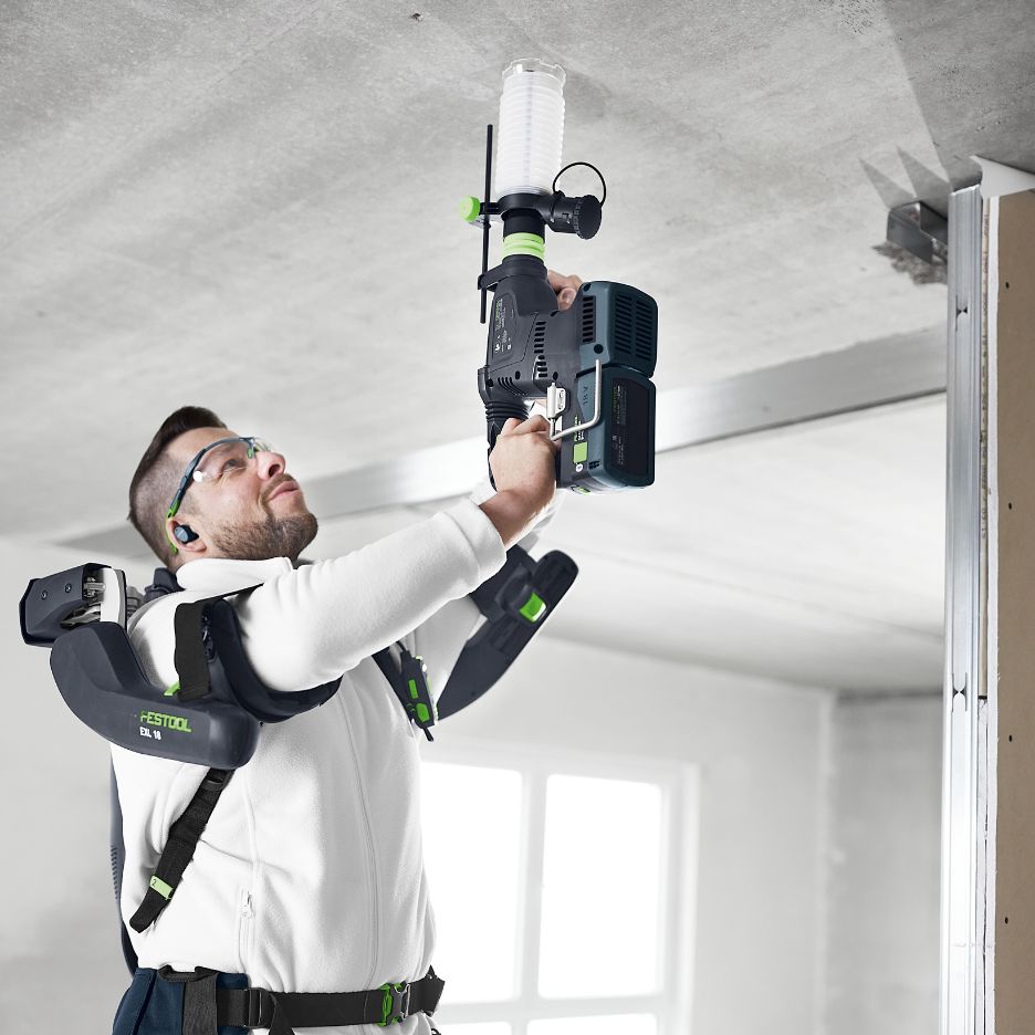 Man wearing ExoActive and using KHC 18 Hammer Dril with Festool Dust Extraction Adapter