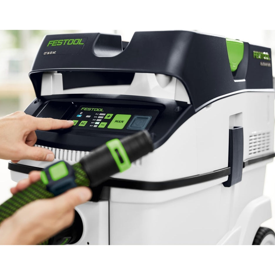 Hand pushing button on CT 36 dust extractor
