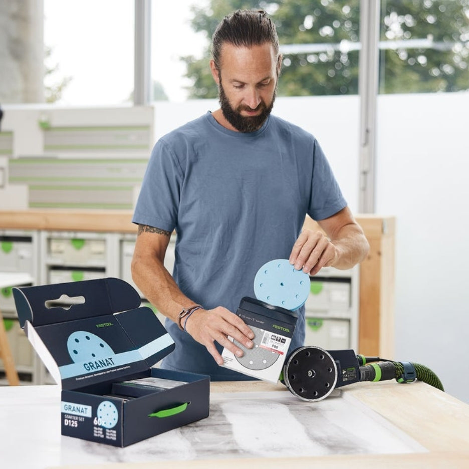 Man holding Festool Granat 5 Inch Abrasive Disc