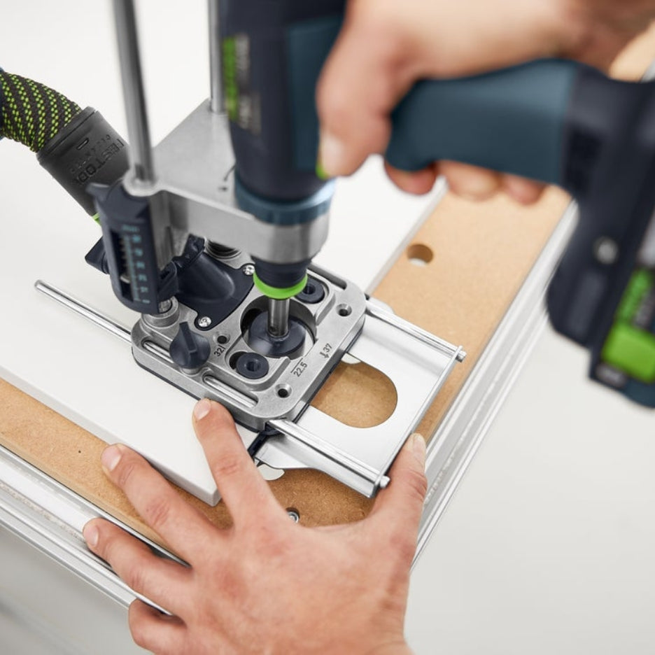 Person using Festool Mobile Drilling Attachment MB 40 attached to drill and forstner bit