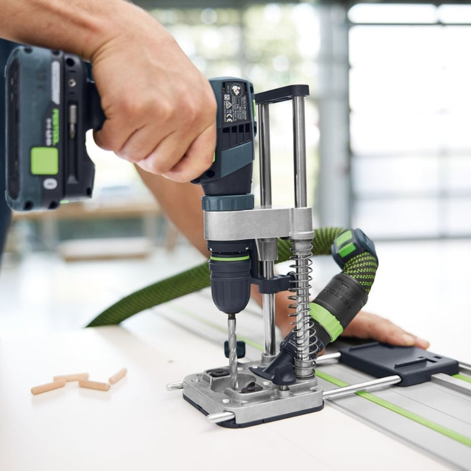 Person using Festool Mobile Drilling Attachment MB 40 with dust extractor and guide rail attached