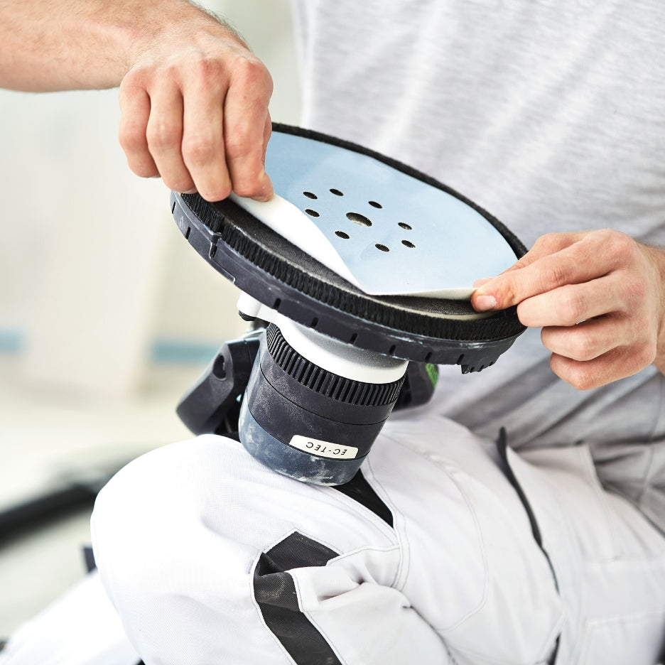 Man attaching abrasive disc to Festool Planex Easy Long-Reach Sander LHS-E 225 EQ-CB