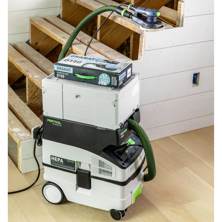 CT MIDI I HEPA Dust Extractor with Systainer and D150 GR-Set Granat Starter Set box, with ETS EC 150/5 Plus Random Orbit Sander on staircase.