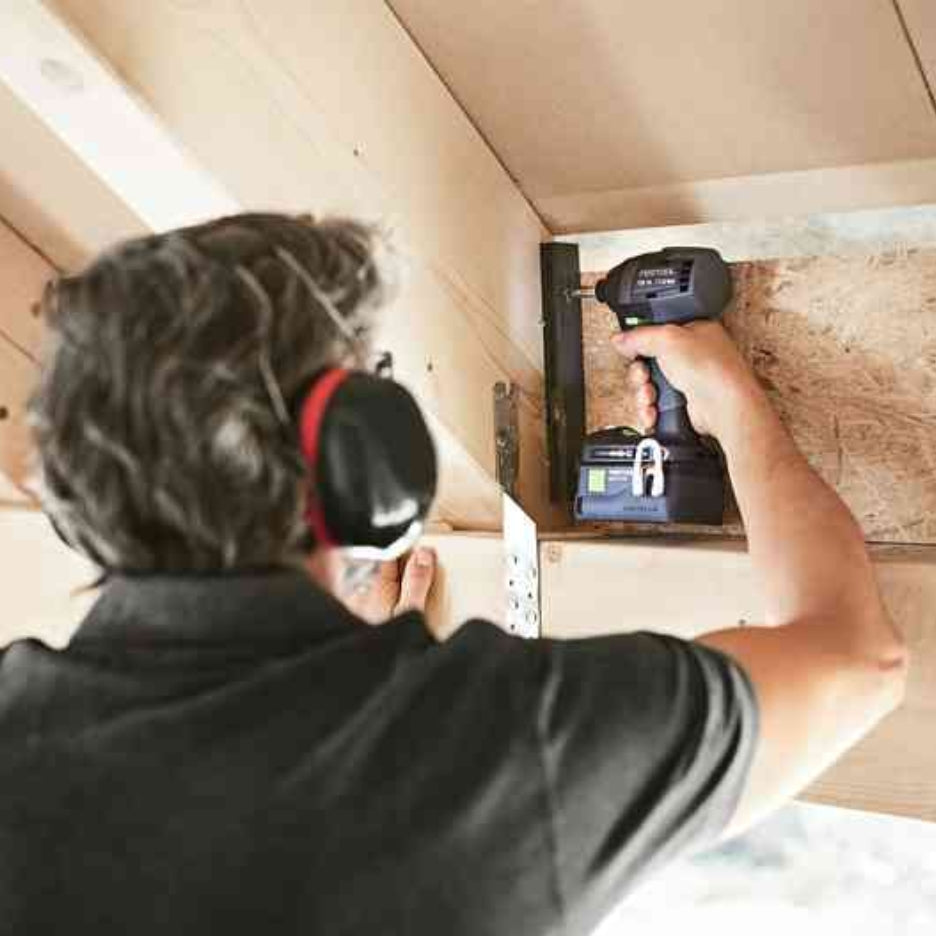 Man using Festool TID 18 cordless impact screwdriver on roof framing
