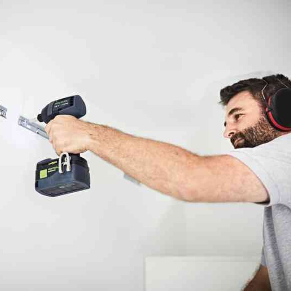 Man using Festool TID 18 cordless impact screwdriver on a metal rail