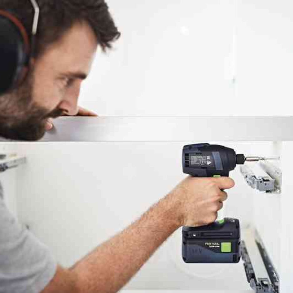Man using Festool TID 18 cordless impact screwdriver on furniture