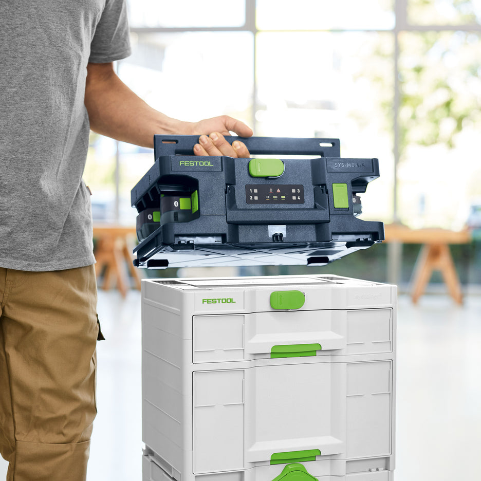 Man is placing Festool Systainer Multi-Bay Rapid Charger on top of other toolboxes.