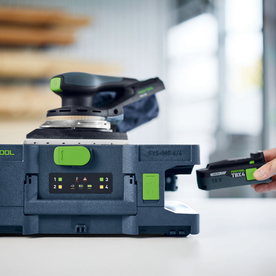 Festool Systainer Multi-Bay Rapid Charger with sander on top and battery being removed