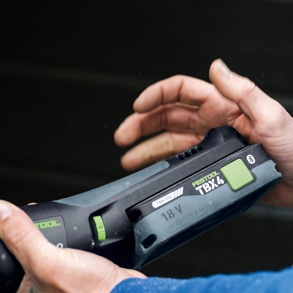 Hand attaching Festool Tabless Battery into power tool
