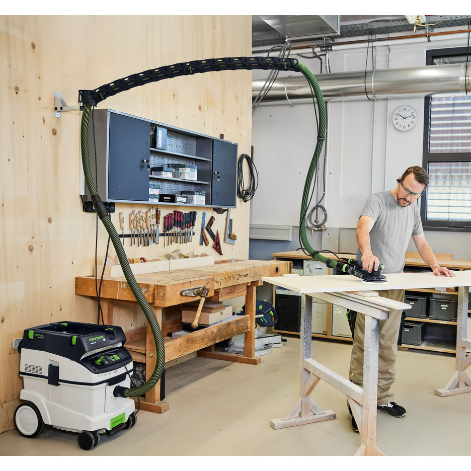 Festool CT 36 dust extractor is connected to a sander, and hose and power cord are suspended overhead by Wall-Mount Boom Arm Set.