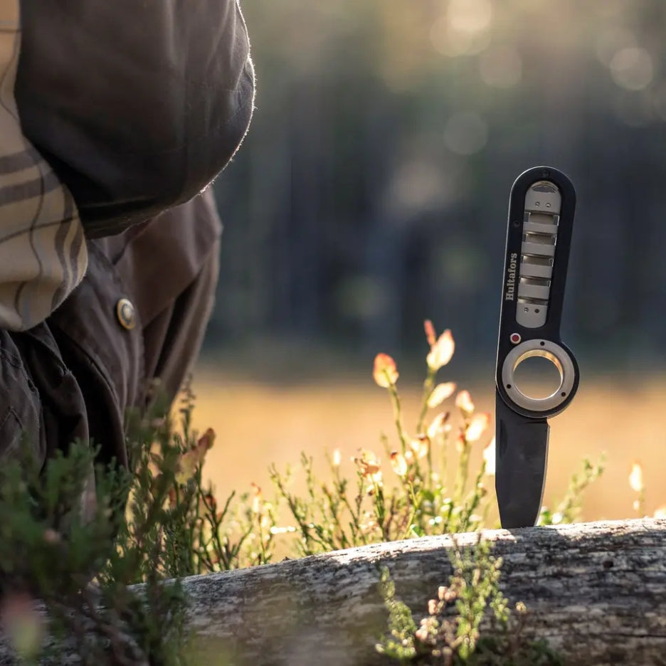 Hultafors Outdoor Folding Knife stuck in a tree trunk
