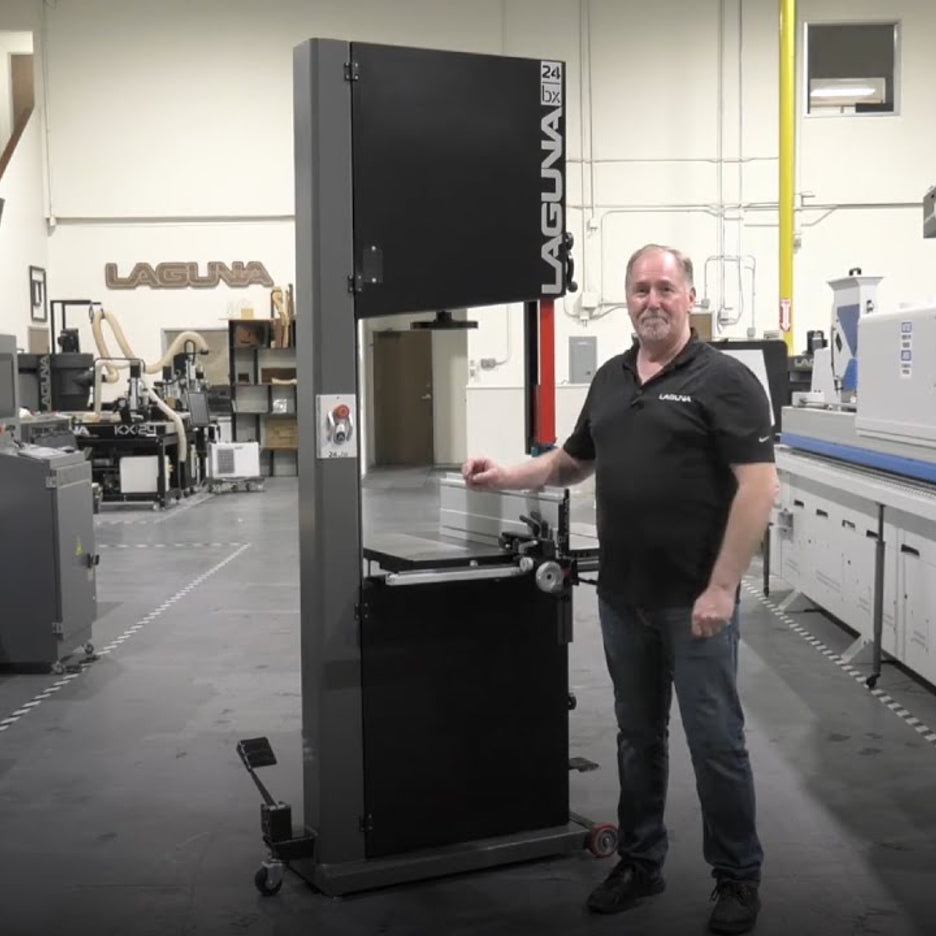 Man standing next to Laguna 24|BX bandsaw in a Laguna facility showing the impressive height of the saw