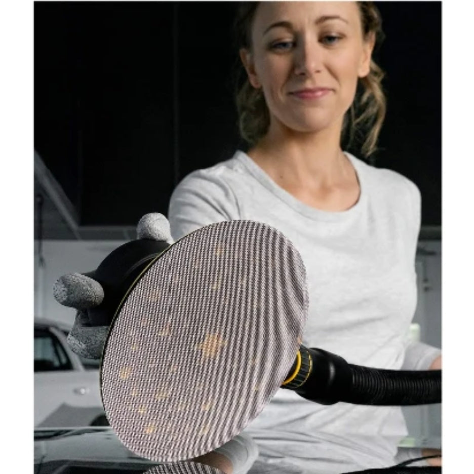 Woman holding sander with Mirka Abranet Ace Mesh Discs