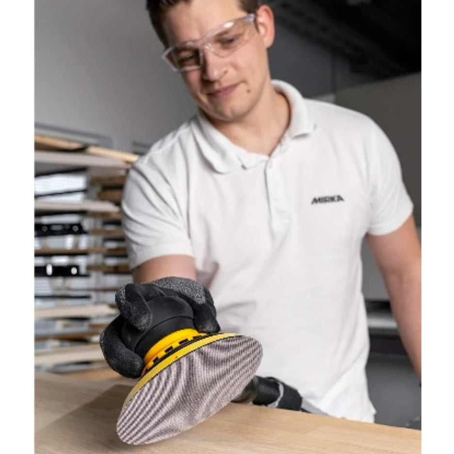 Man sanding with Mirka Abranet Ace Mesh Disc