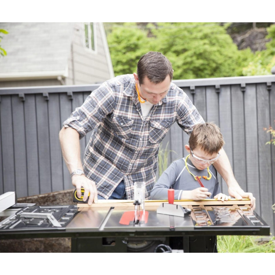 Man and kid marking a piece of wood on top of SawStop Contractor Saw