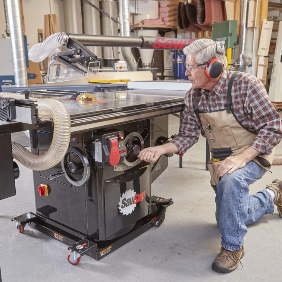 Man adjusting Industrial Table on SawStop Industrial Mobile Base with Hydraulics for ICS