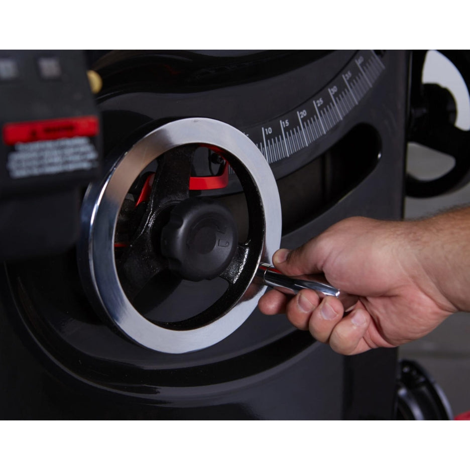 Hand adjusting SawStop Professional Cabinet Table Saw using elevation hand wheel