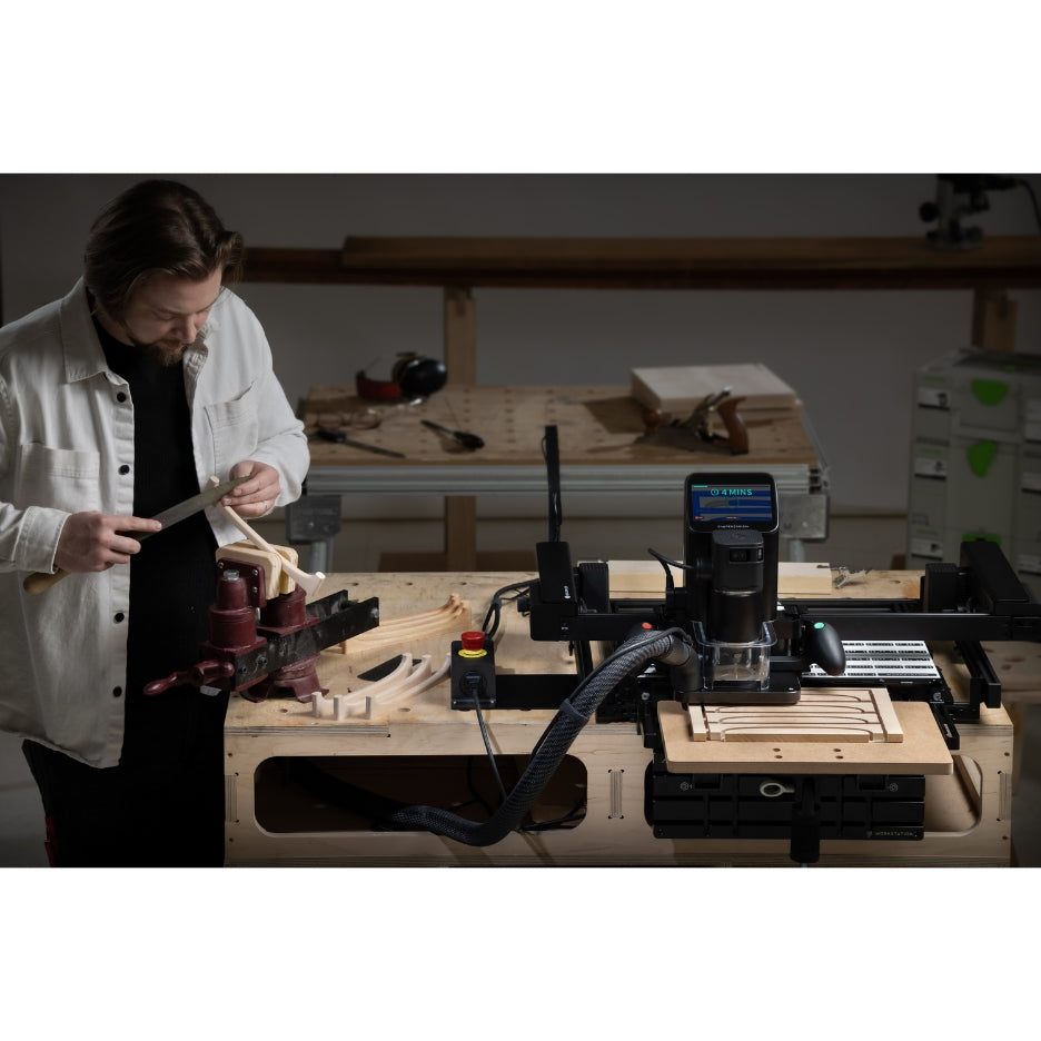 Man working on a project close to Shaper Tools BenchPilot attached to Origin and Workstation