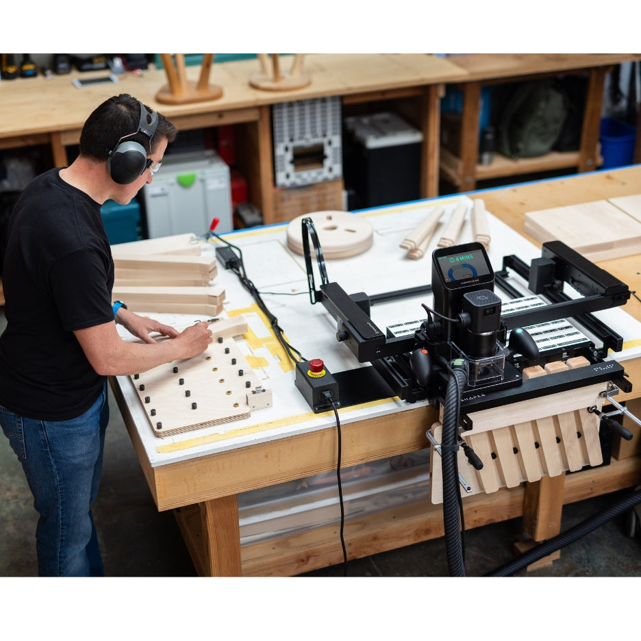 Man working on a project with Shaper Tools BenchPilot attached to Origin and Workstation