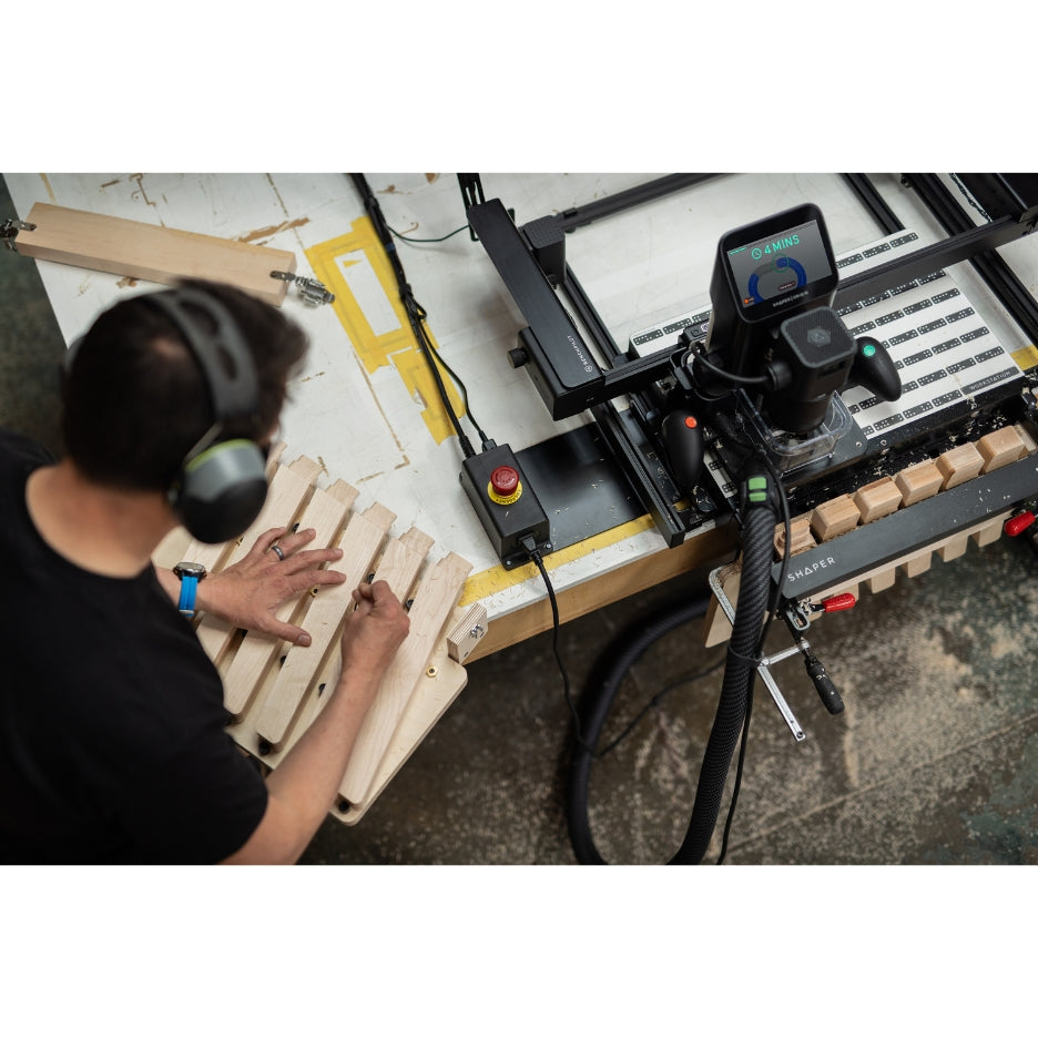 Upper view of man working on a project with Shaper Tools BenchPilot attached to Origin and Workstation