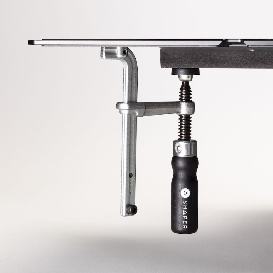 Low-profile screw clamps secure plate to a workpiece.