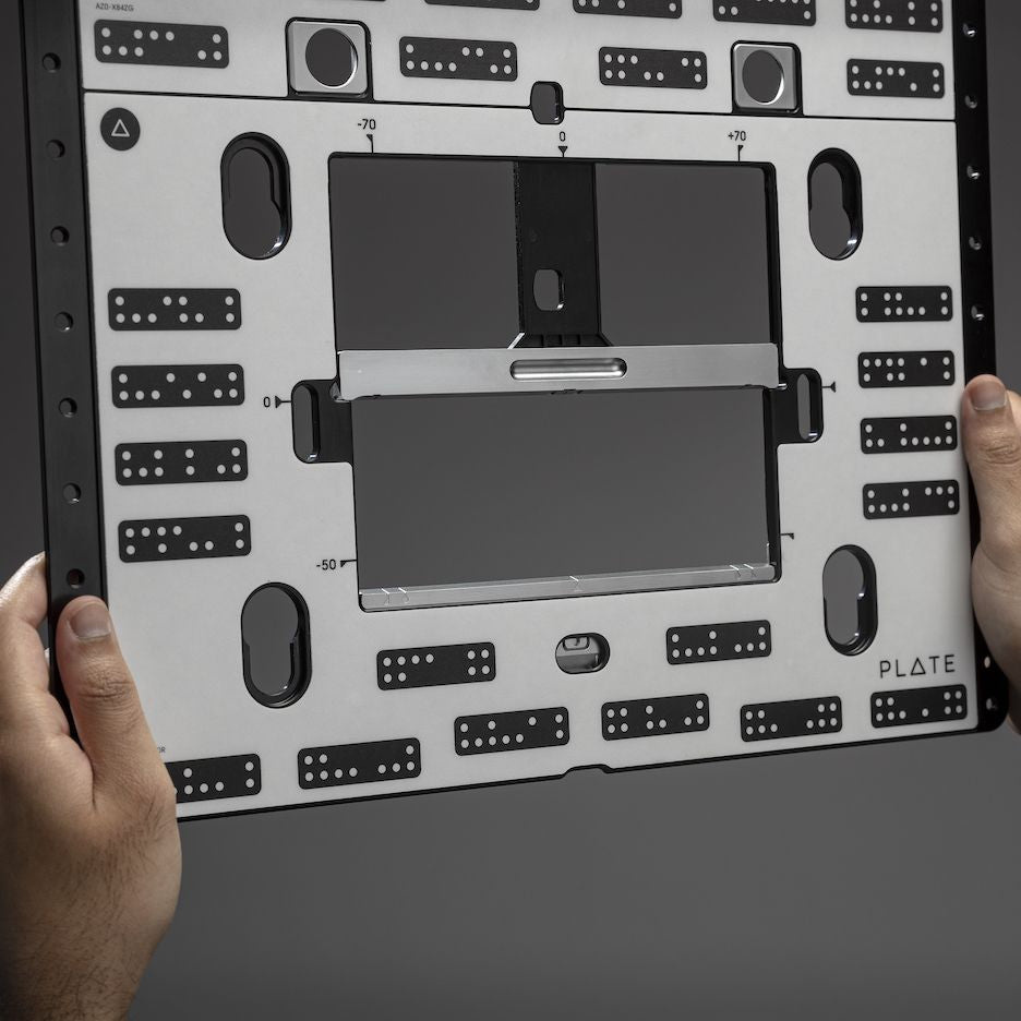 Man holds Shaper Plate in his hands.